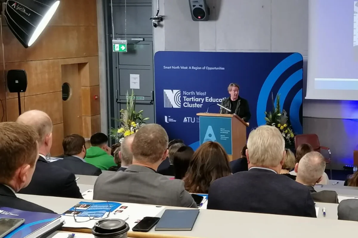 Presenter speaking from a podium in a lecture hall