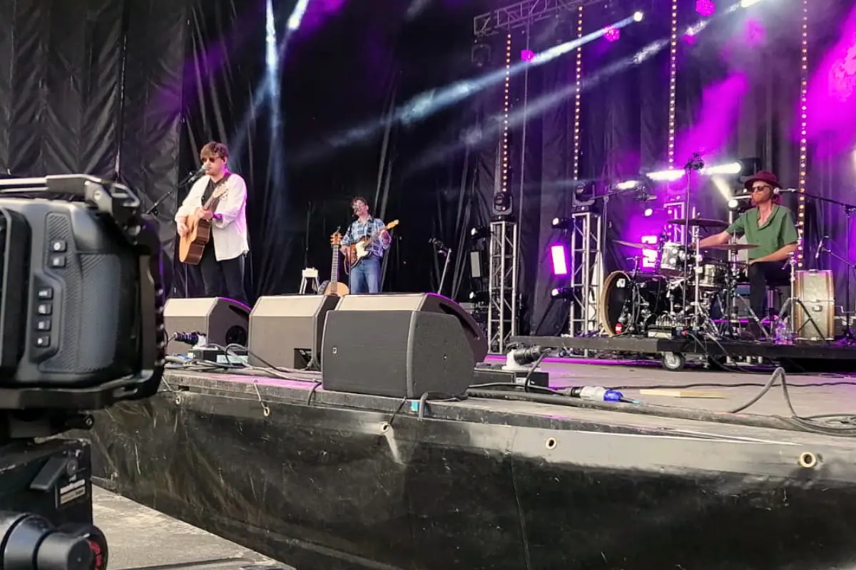 Live band performing on a stage with professional sound and lighting equipment