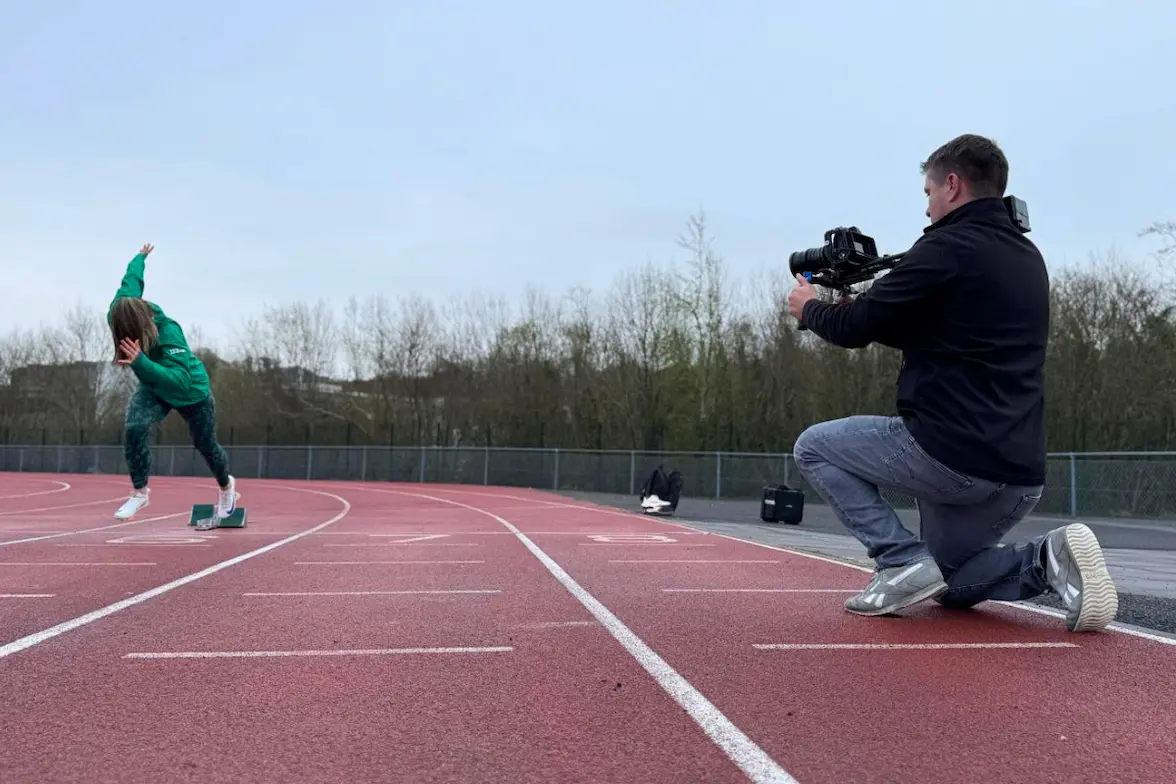 StudioRove filming a promotional video at an outdoor athletics track
