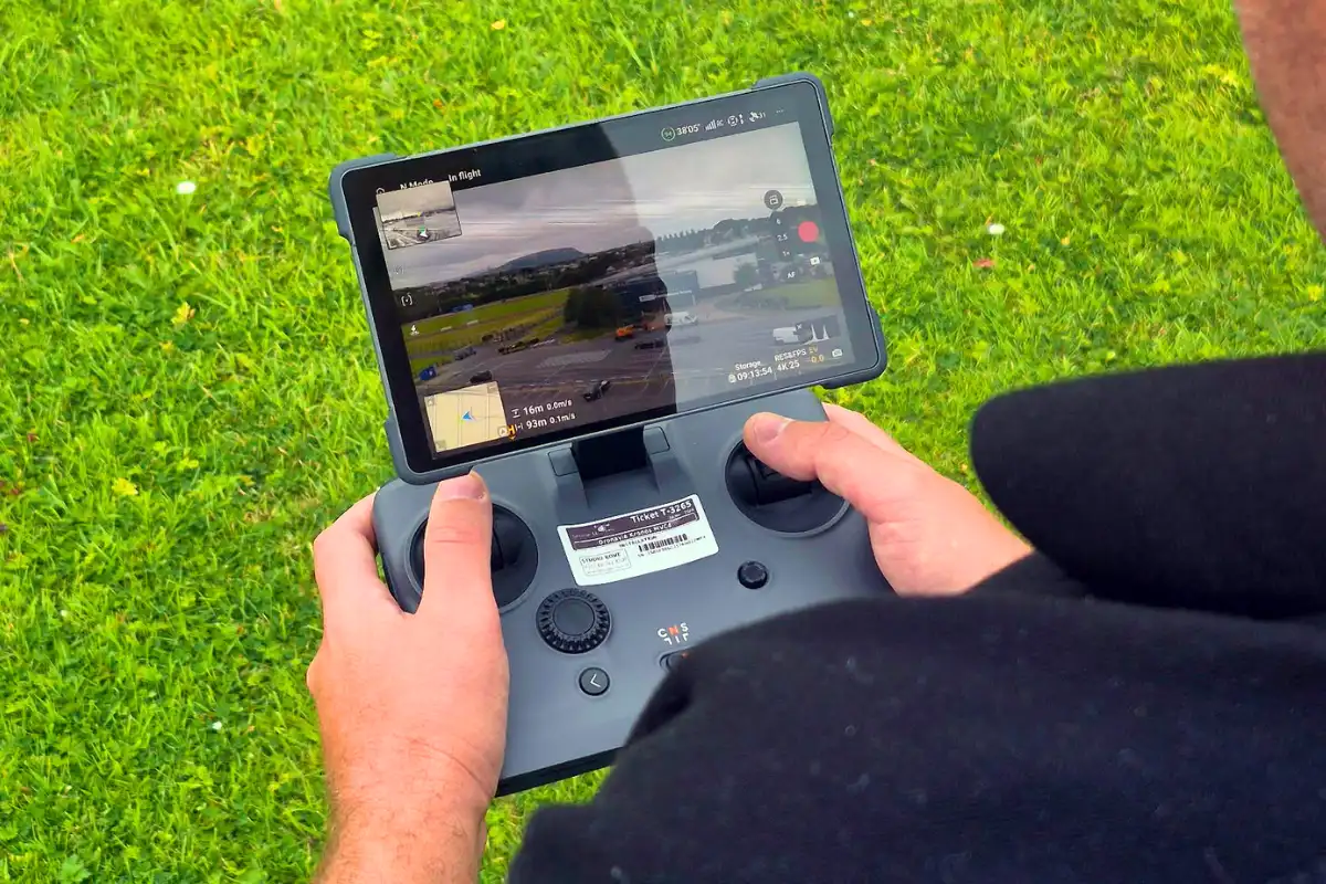 Drone operator using a remote controller to capture aerial footage in Ireland